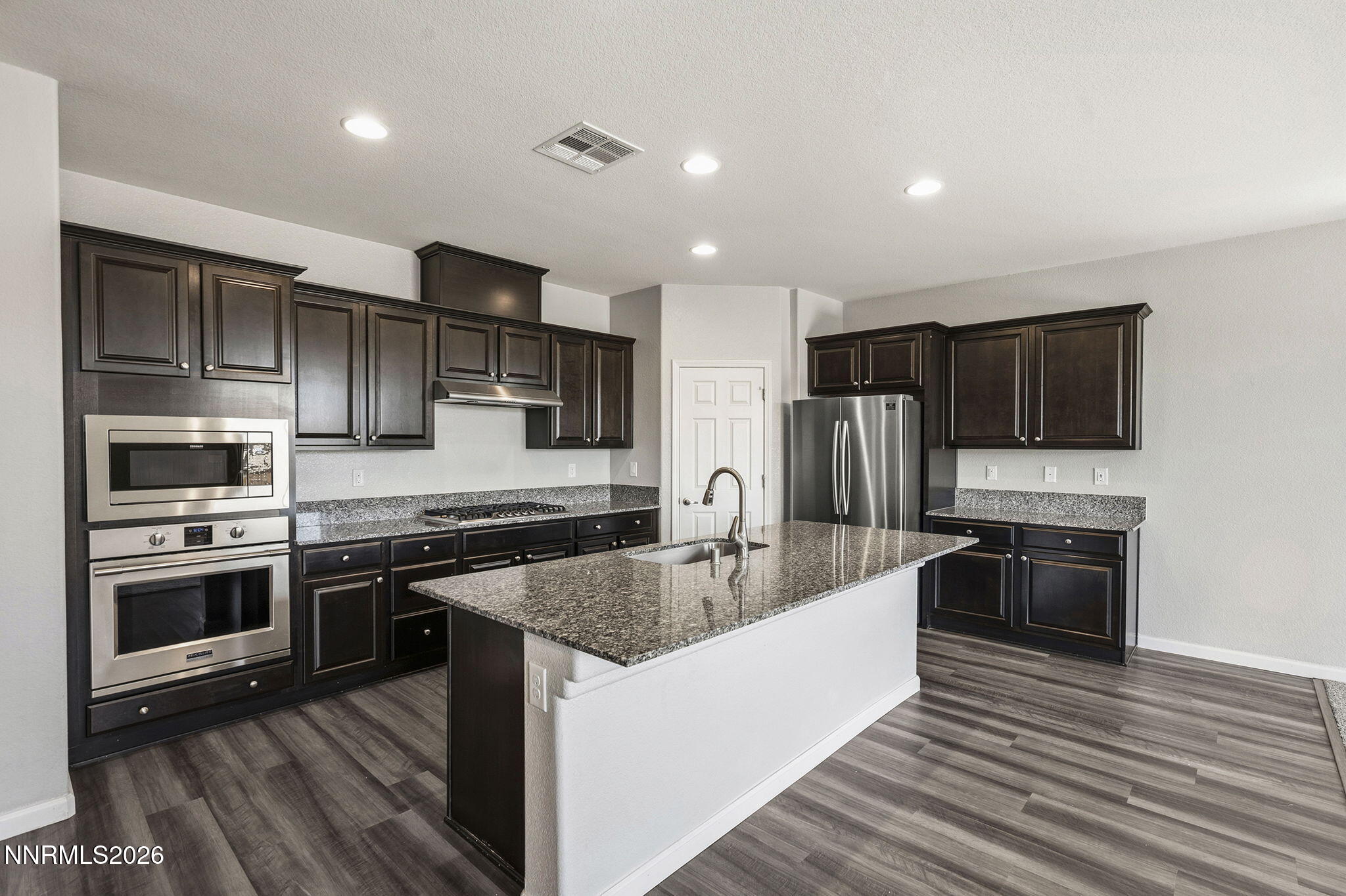 14138 Glowing Amber Court Reno, NV 89511 - Photo 11 of 36 a kitchen with stainless steel appliances granite countertop a sink stove and refrigerator