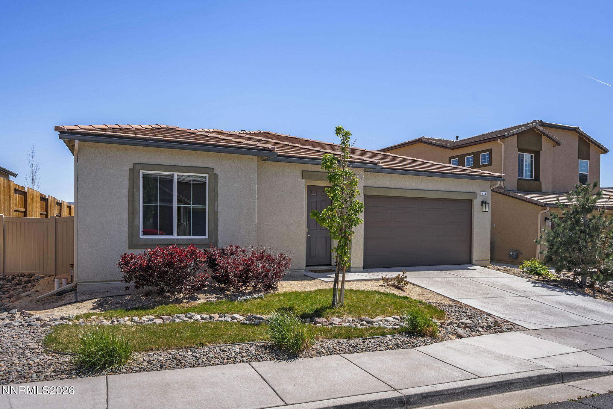 14138 Glowing Amber Court Reno, NV 89511 - Photo 2 of 36 a front view of a house with garden