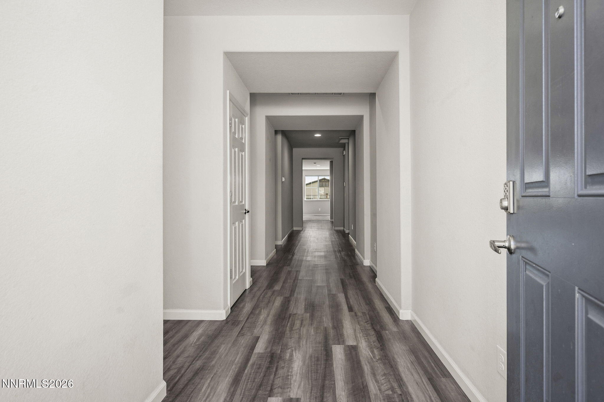 14138 Glowing Amber Court Reno, NV 89511 - Photo 3 of 36 a view of a hallway with wooden floor and a bathroom