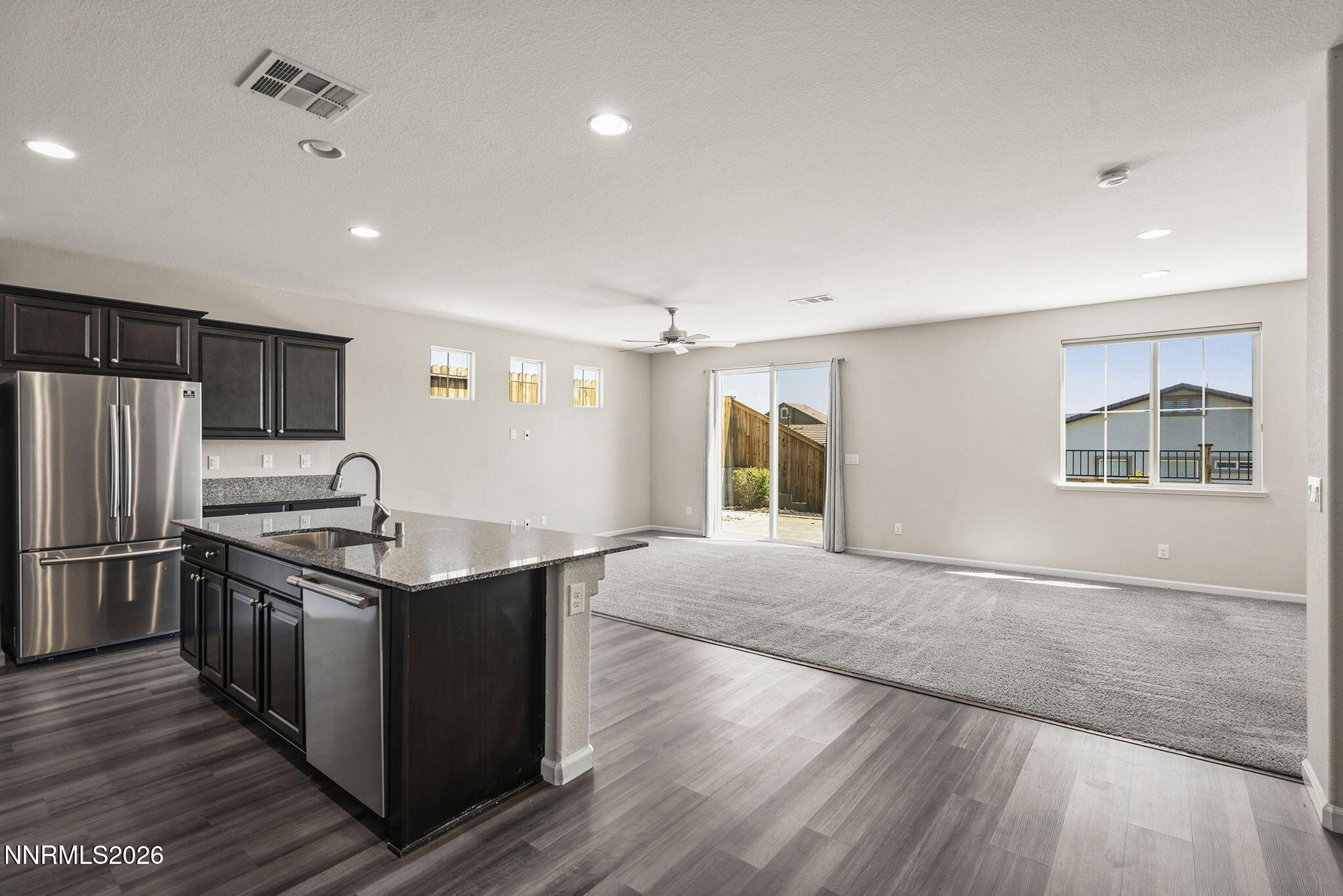 14138 Glowing Amber Court Reno, NV 89511 - Photo 4 of 36 a kitchen with stainless steel appliances granite countertop a sink stove and refrigerator
