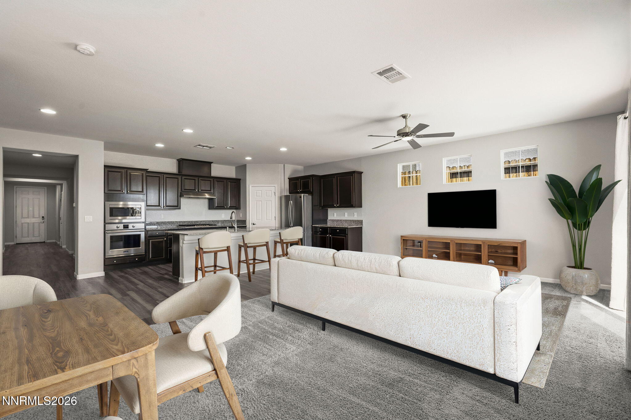 14138 Glowing Amber Court Reno, NV 89511 - Photo 8 of 36 a living room with furniture a flat screen tv and kitchen view