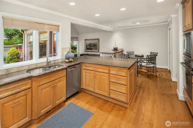 a kitchen with a sink window and cabinets