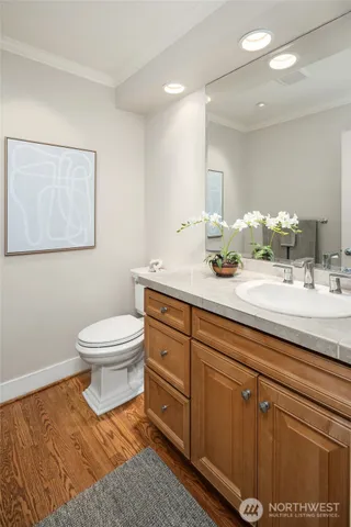 a bathroom with a toilet sink and mirror