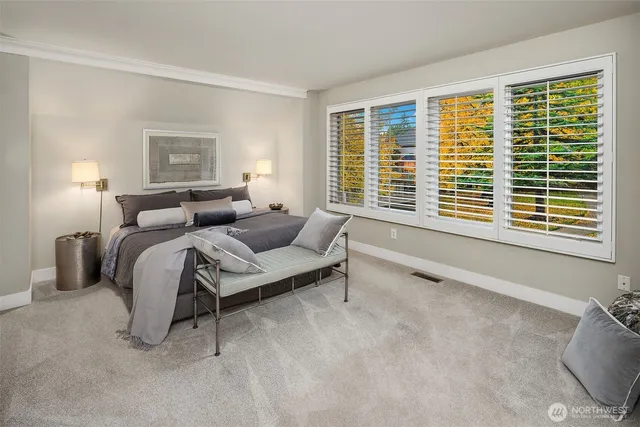 a bedroom with bed and a large window