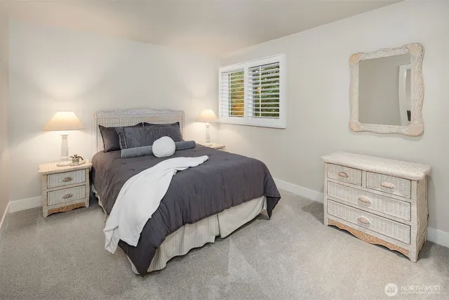 a bedroom with a bed and a night stand