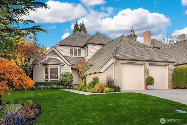 a front view of a house with a garden and plants