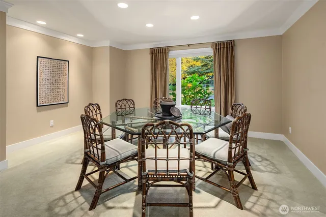 a view of a dining room with furniture and a large window