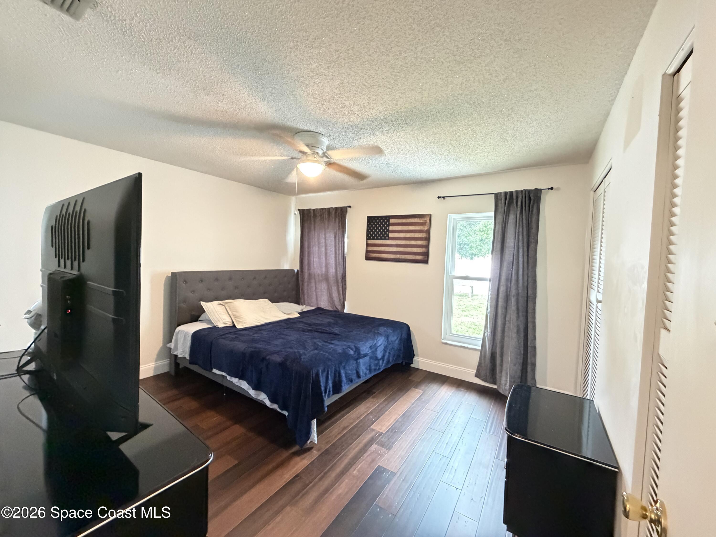 1578 West Powder Horn Road Titusville, FL 32796 - Photo 9 of 22 a bedroom with double bed and a window