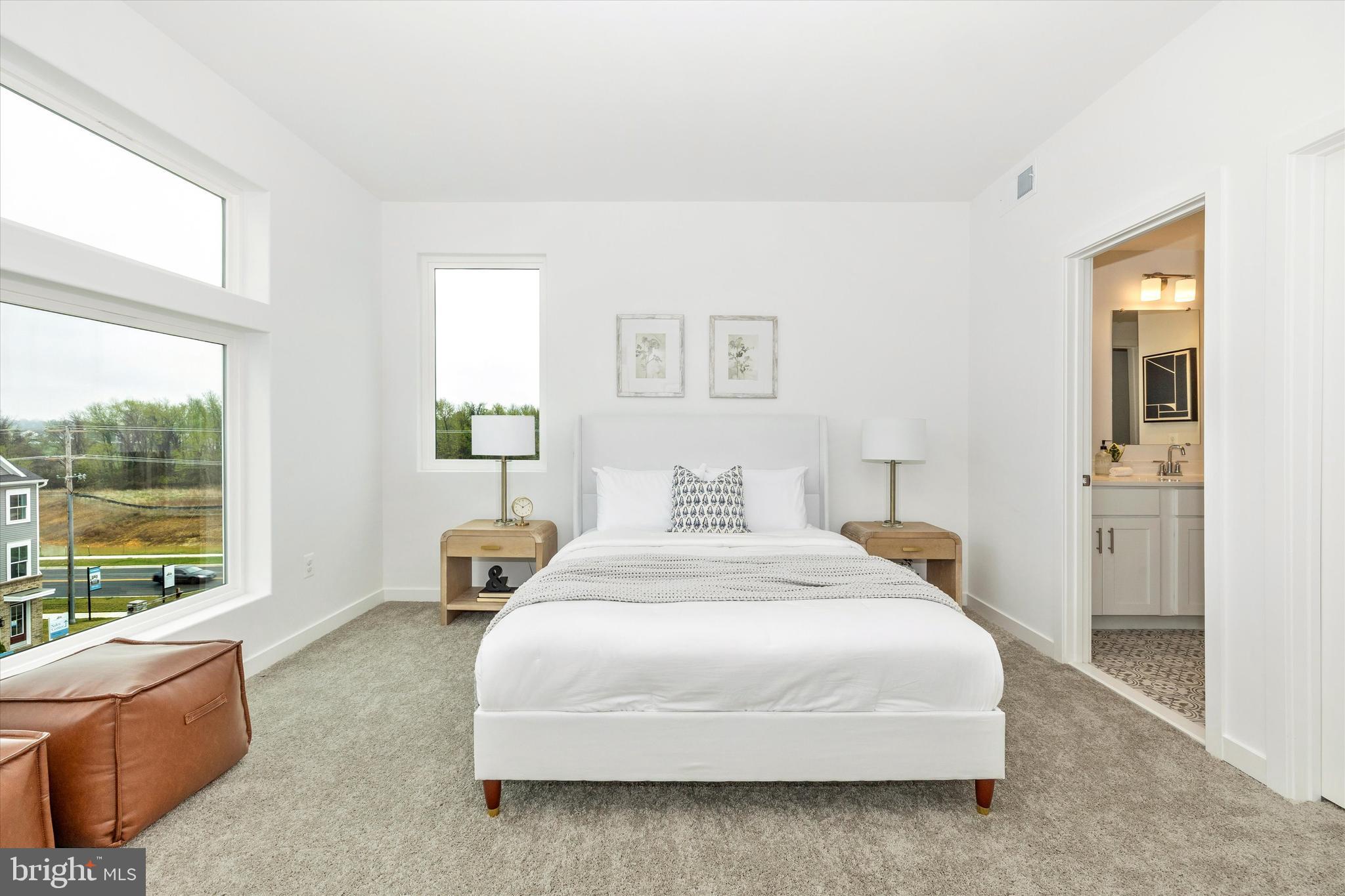 709 B Iron Frg Road Frederick, MD 21702 - Photo 22 of 32 a bedroom with a bed and large windows