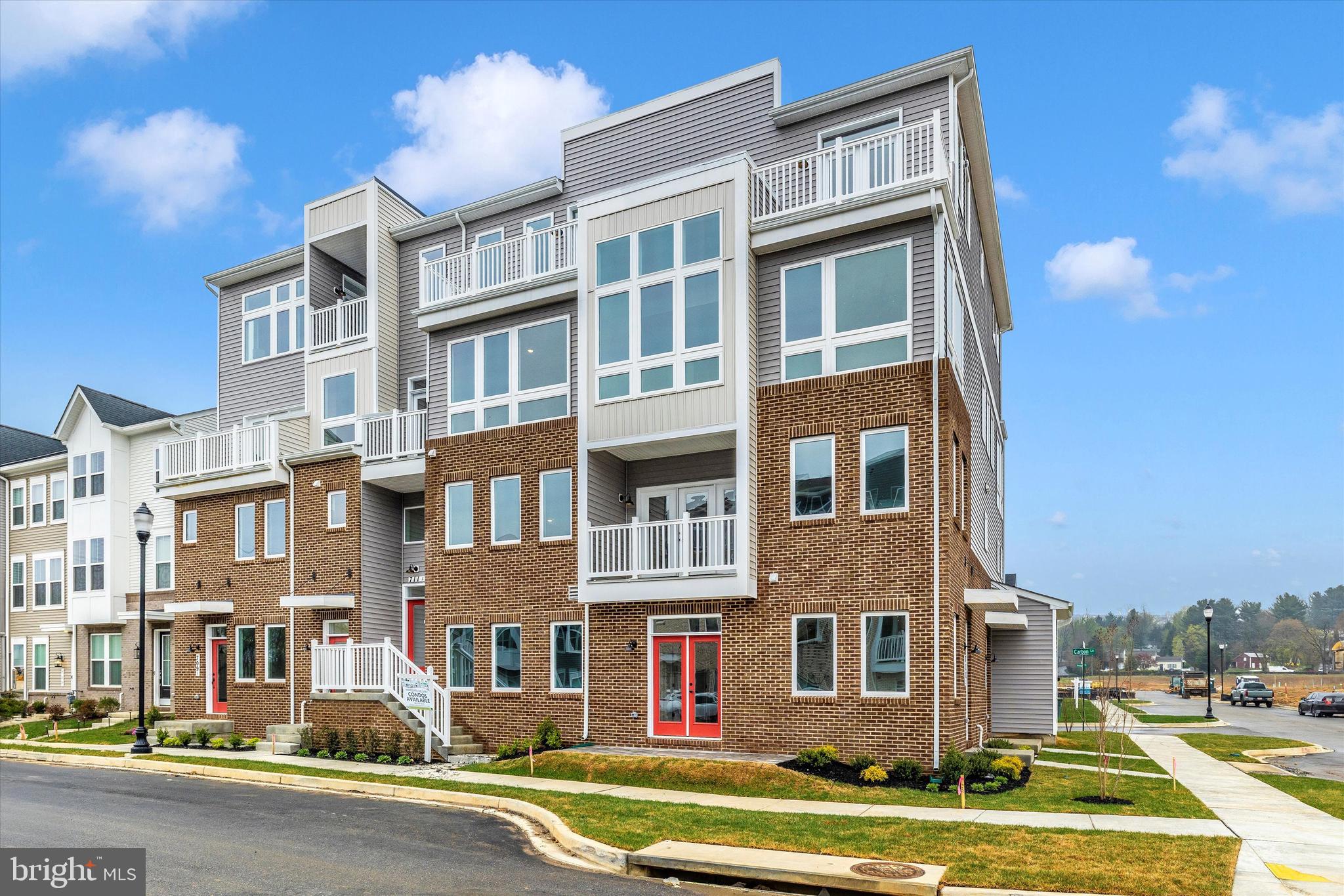 709 B Iron Frg Road Frederick, MD 21702 - Photo 31 of 32 a front view of a residential apartment building with a yard