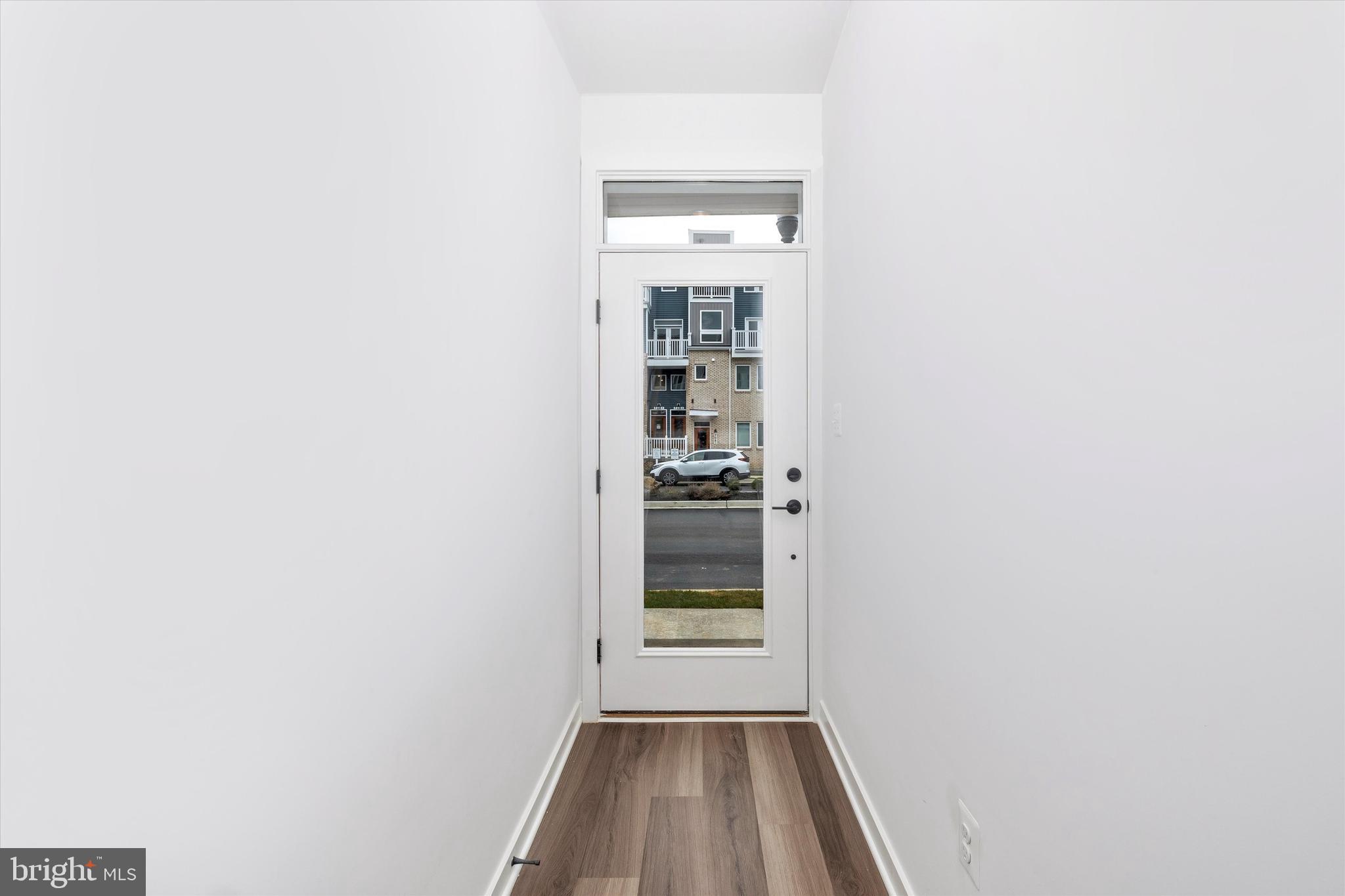 709 B Iron Frg Road Frederick, MD 21702 - Photo 4 of 32 a view of a hallway with wooden floor and a window