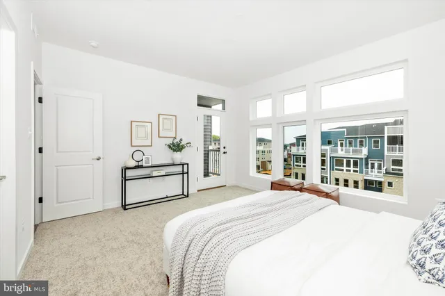 a spacious bedroom with a bed and a large window