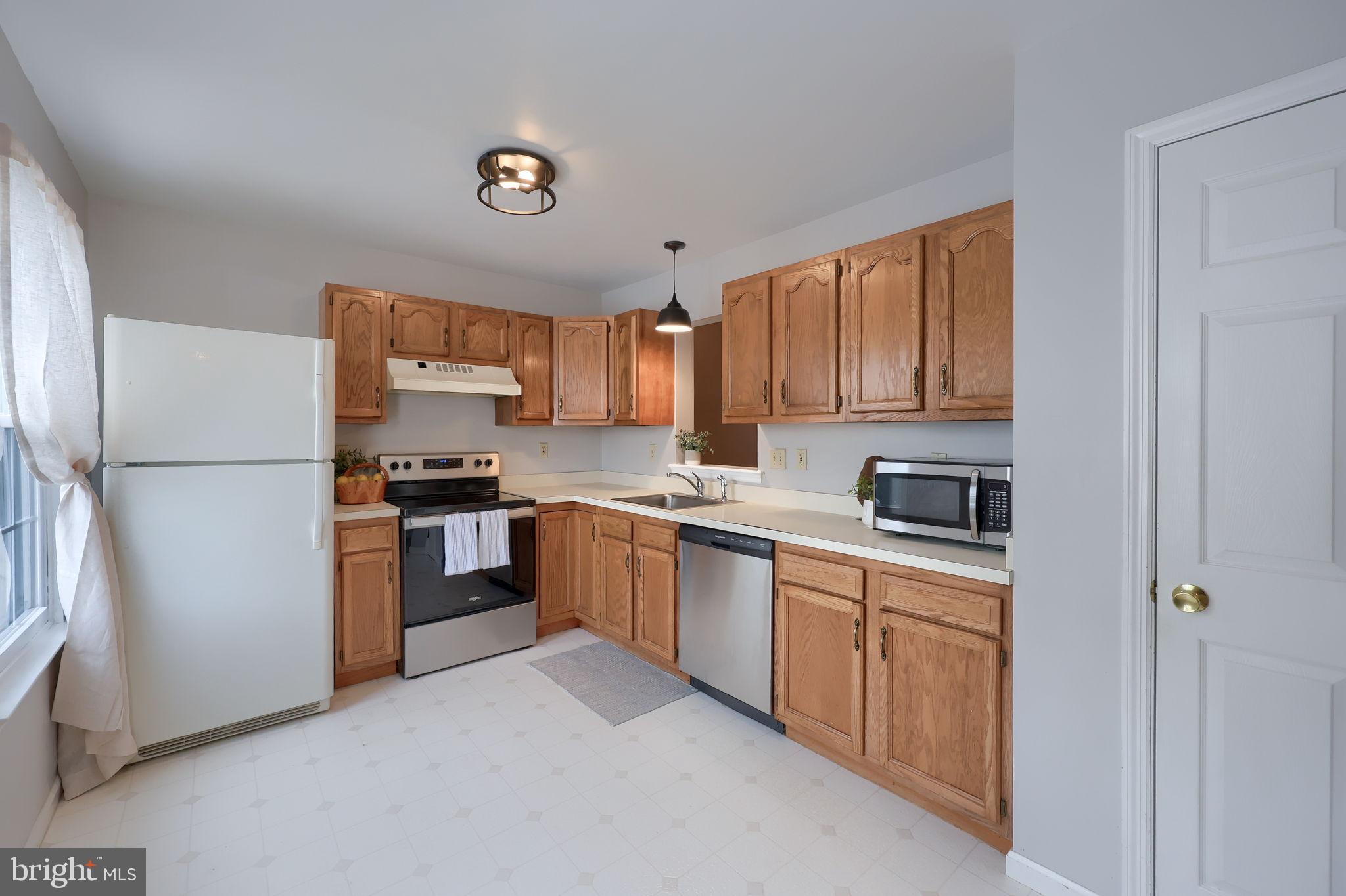 2904 Newport Way Reading, PA 19608 - Photo 7 of 35 Bright and inviting kitchen with warm wood tones.
