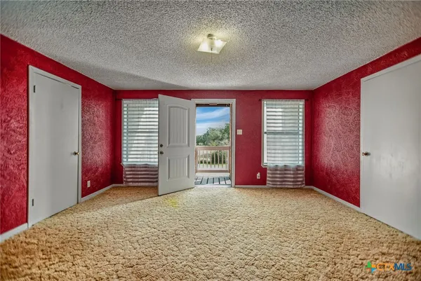 a view of a big room with windows and closet