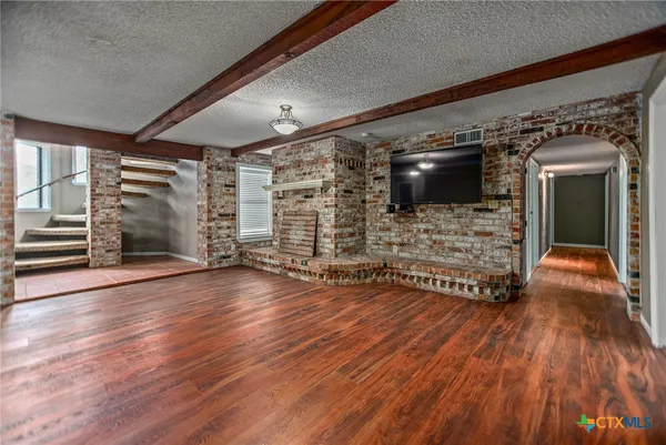 a view of a livingroom with wooden floor