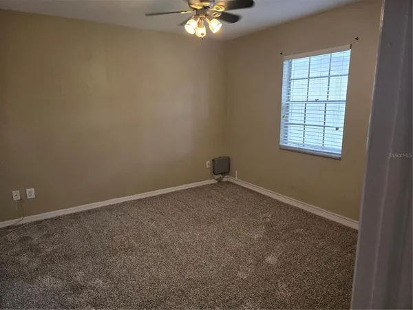 a bathroom with a granite countertop sink toilet a mirror and shower