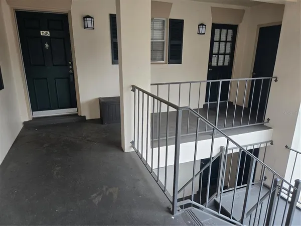 a view of staircase with lots of frames on wall and a window