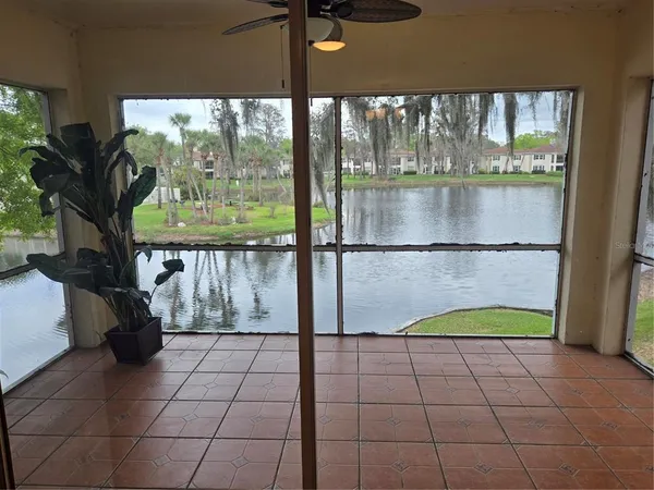 a view of a living room with a floor to ceiling window and pool table