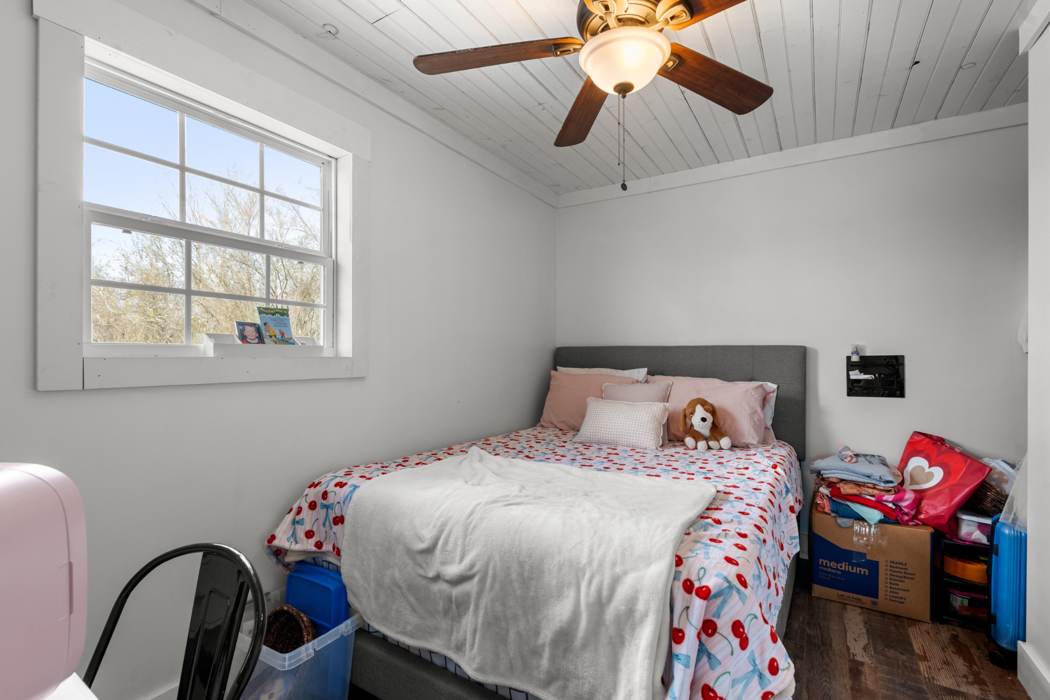 168 Mackin Road Linden, TN 37096 - Photo 24 of 32 a bedroom with a bed and a chandelier