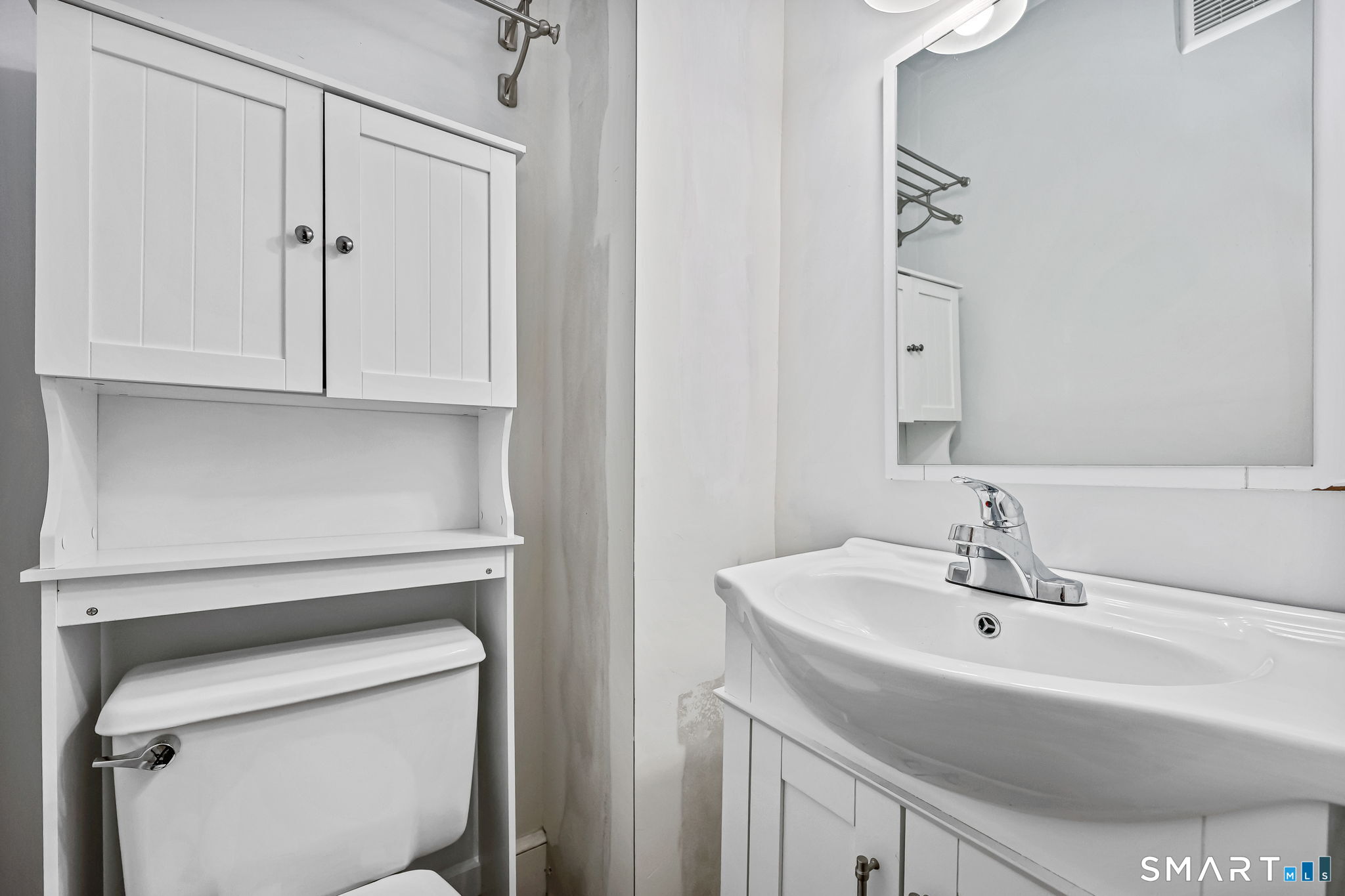 105 Knickerbocker Avenue Stamford, CT 06907 - Photo 19 of 31 a bathroom with a sink a toilet and a mirror