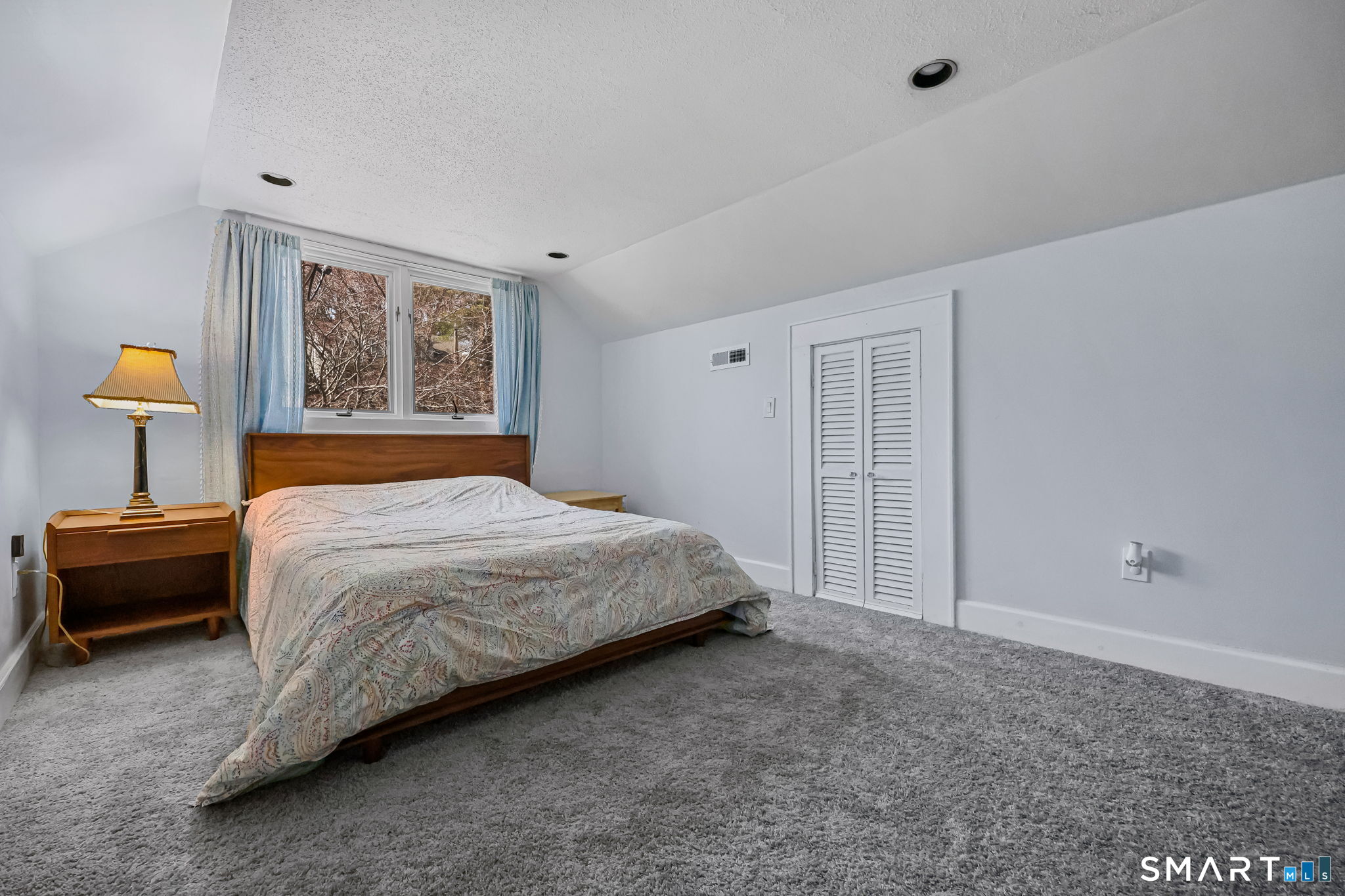 105 Knickerbocker Avenue Stamford, CT 06907 - Photo 20 of 31 a bedroom with a bed and a lamp on dresser