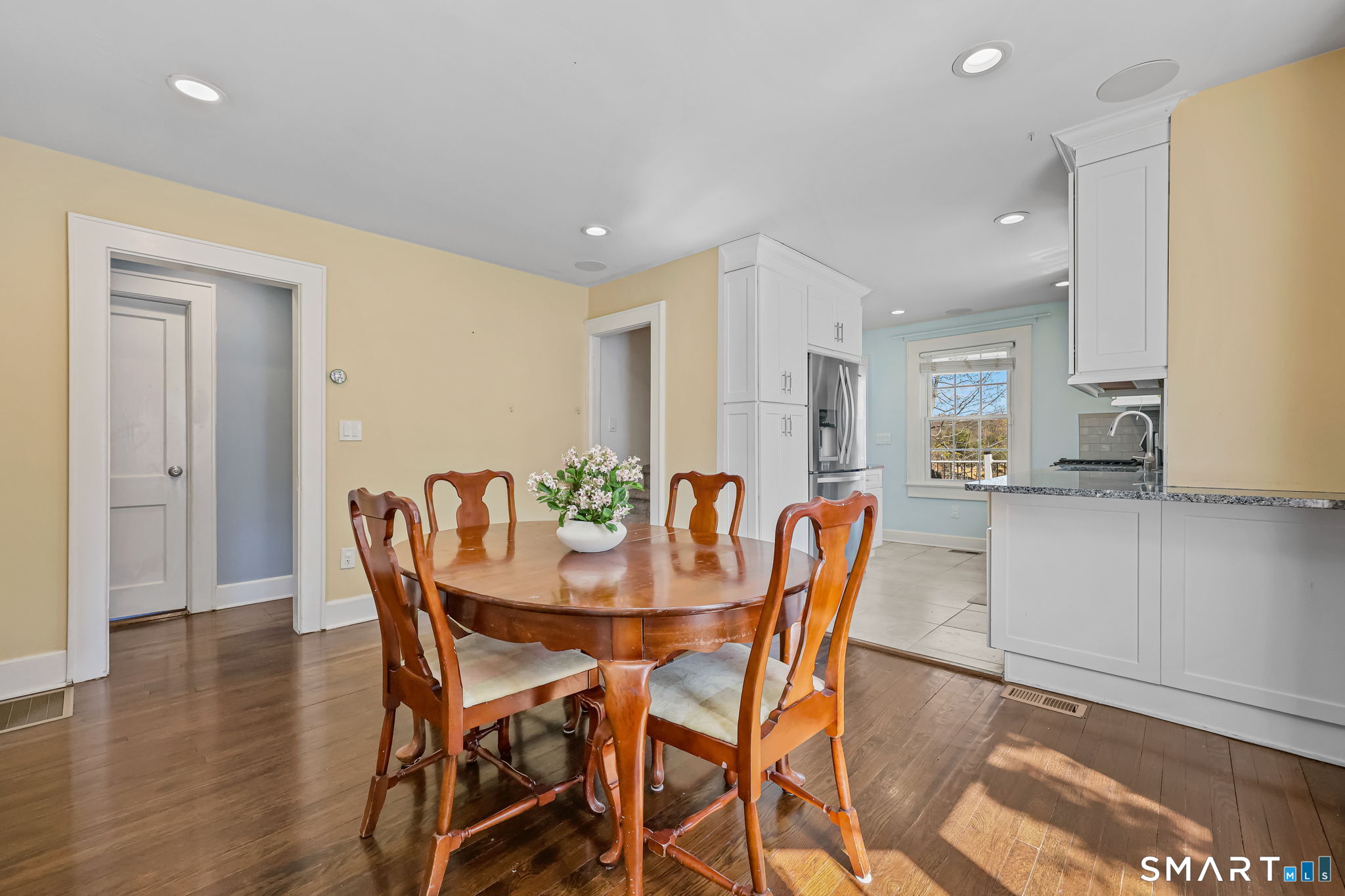 105 Knickerbocker Avenue Stamford, CT 06907 - Photo 9 of 31 a view of a dining room with furniture and wooden floor