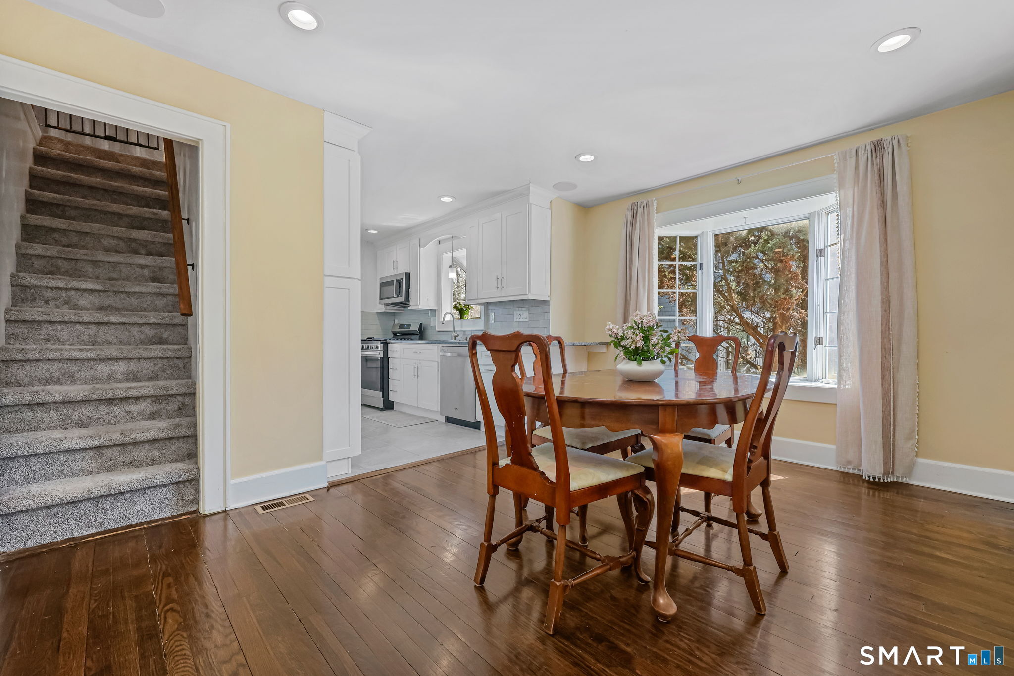 105 Knickerbocker Avenue Stamford, CT 06907 - Photo 10 of 31 a view of a dining room with furniture window and wooden floor