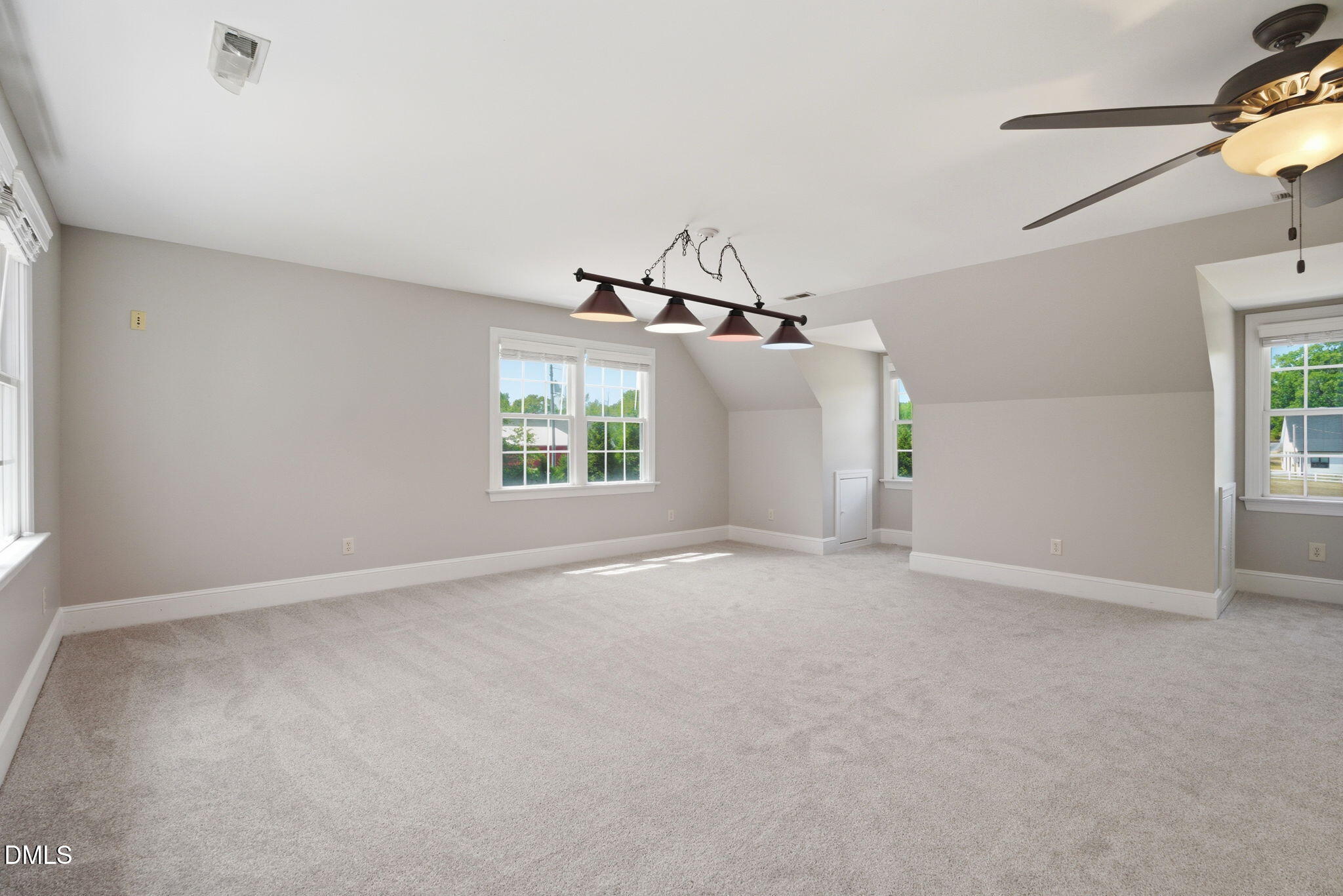 5416 Pulley Town Road Zebulon, NC 27597 - Photo 34 of 74 an empty room with windows and ceiling fan