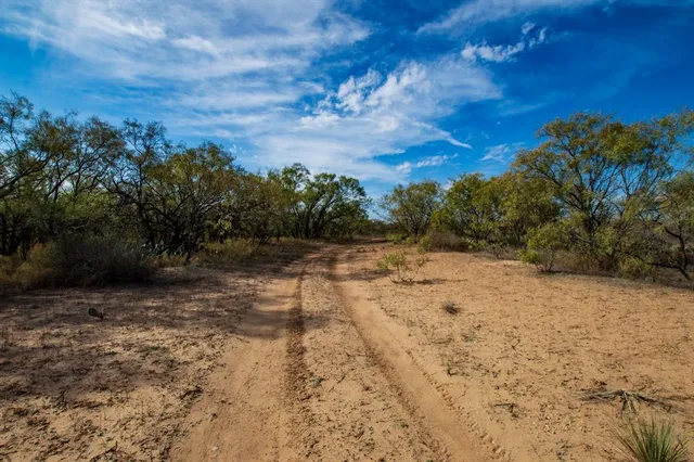 a wooden bench sitting in front of a building