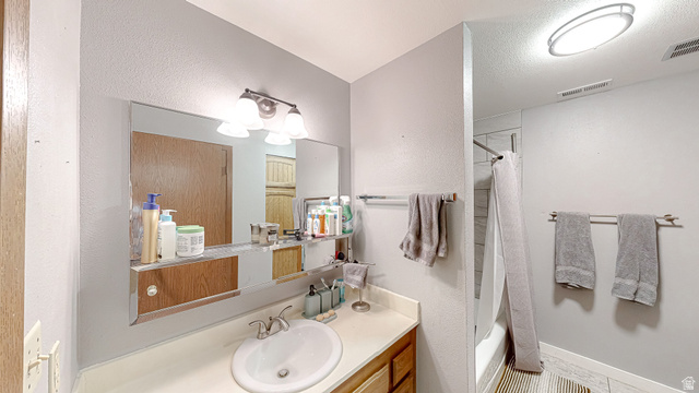 630 1100 West Provo, UT 84601 - Photo 19 of 64 Bathroom featuring a vanity with a white countertop and a built-in sink