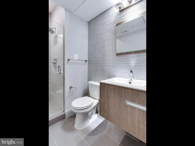 a bathroom with a sink toilet and a mirror