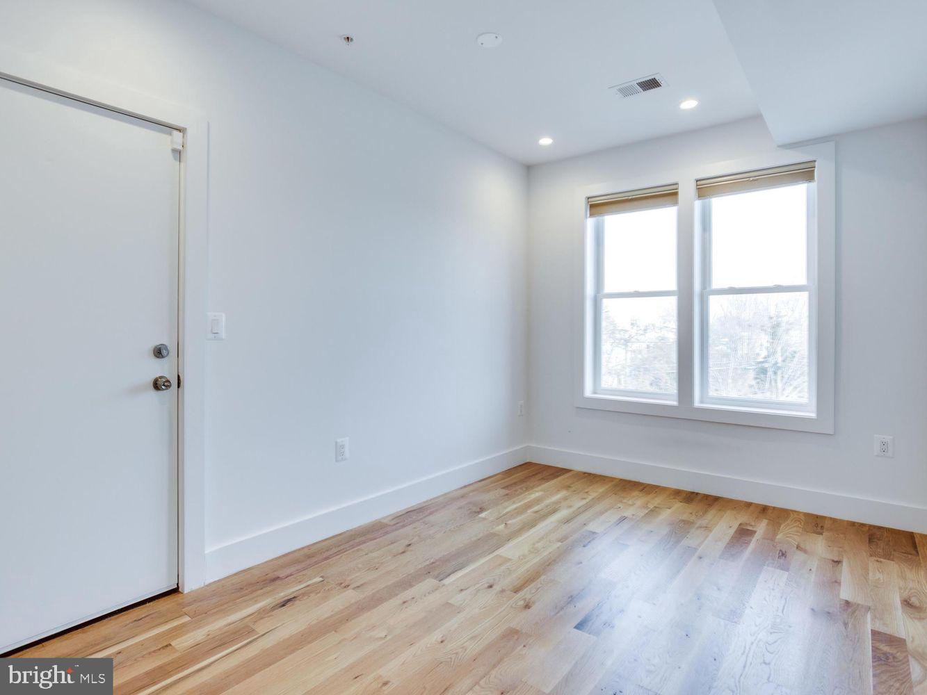 254 15th Street Southeast, Unit 4 Washington, DC 20003 - Photo 19 of 23 an empty room with wooden floor and windows