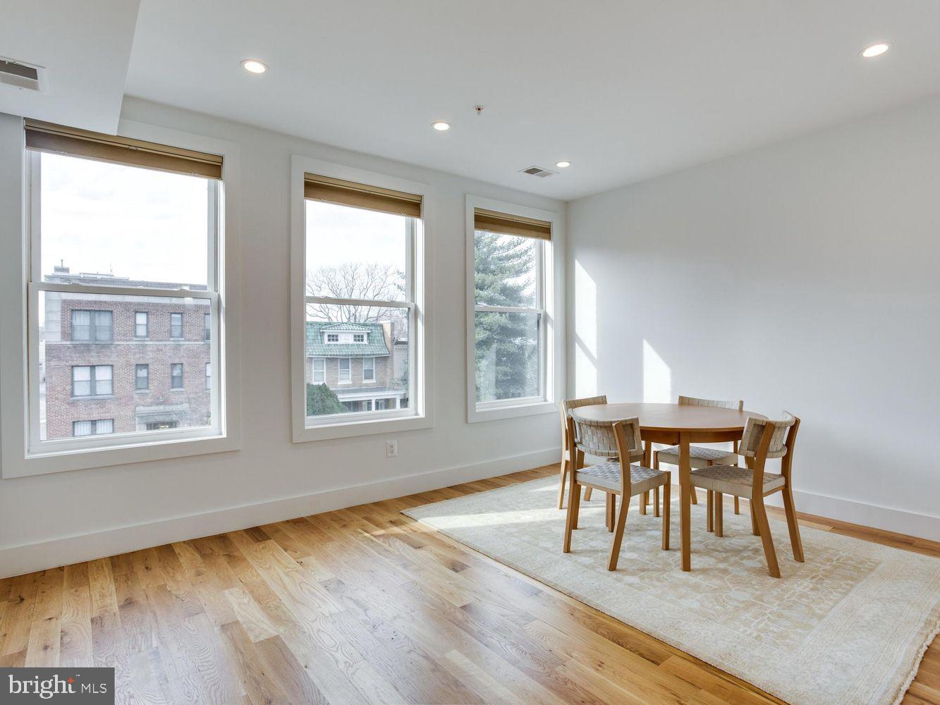 254 15th Street Southeast, Unit 4 Washington, DC 20003 - Photo 8 of 23 a dining room with wooden floor and a floor to ceiling window