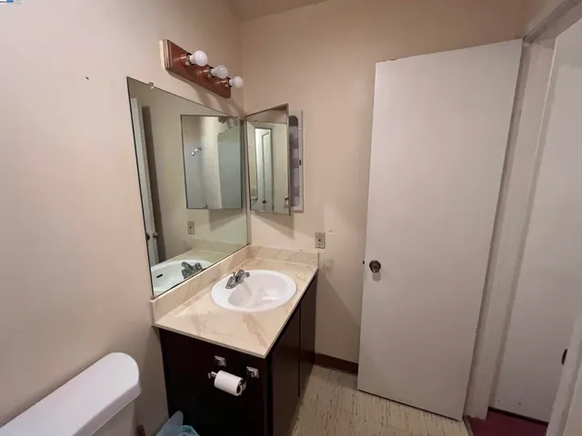 a bathroom with a sink a toilet and mirror