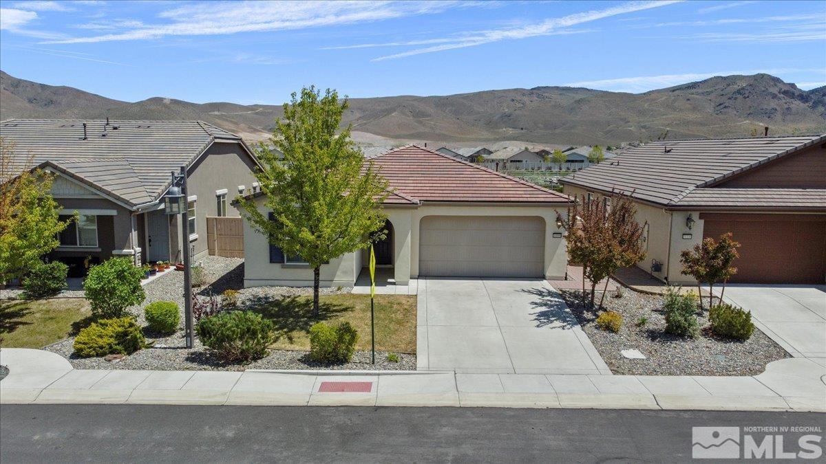 10098 Ignacio Circle Reno, NV 89521 - Photo 1 of 40 a front view of a house with a yard and mountain view