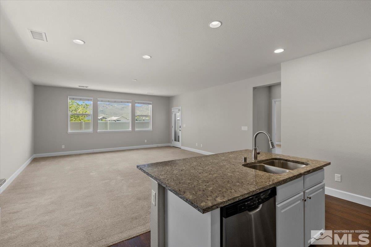 10098 Ignacio Circle Reno, NV 89521 - Photo 15 of 40 a kitchen with kitchen island a counter top space and a sink