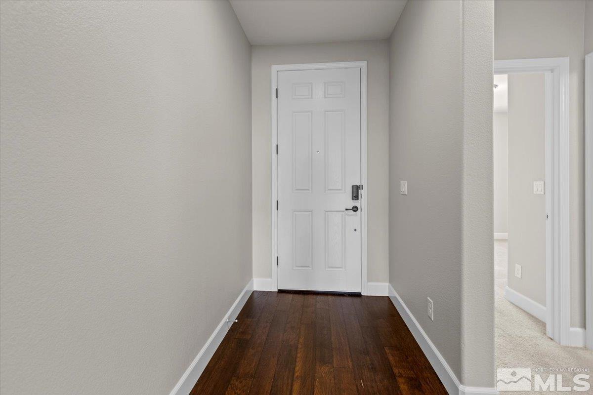 10098 Ignacio Circle Reno, NV 89521 - Photo 28 of 40 a view of a hallway with wooden floor