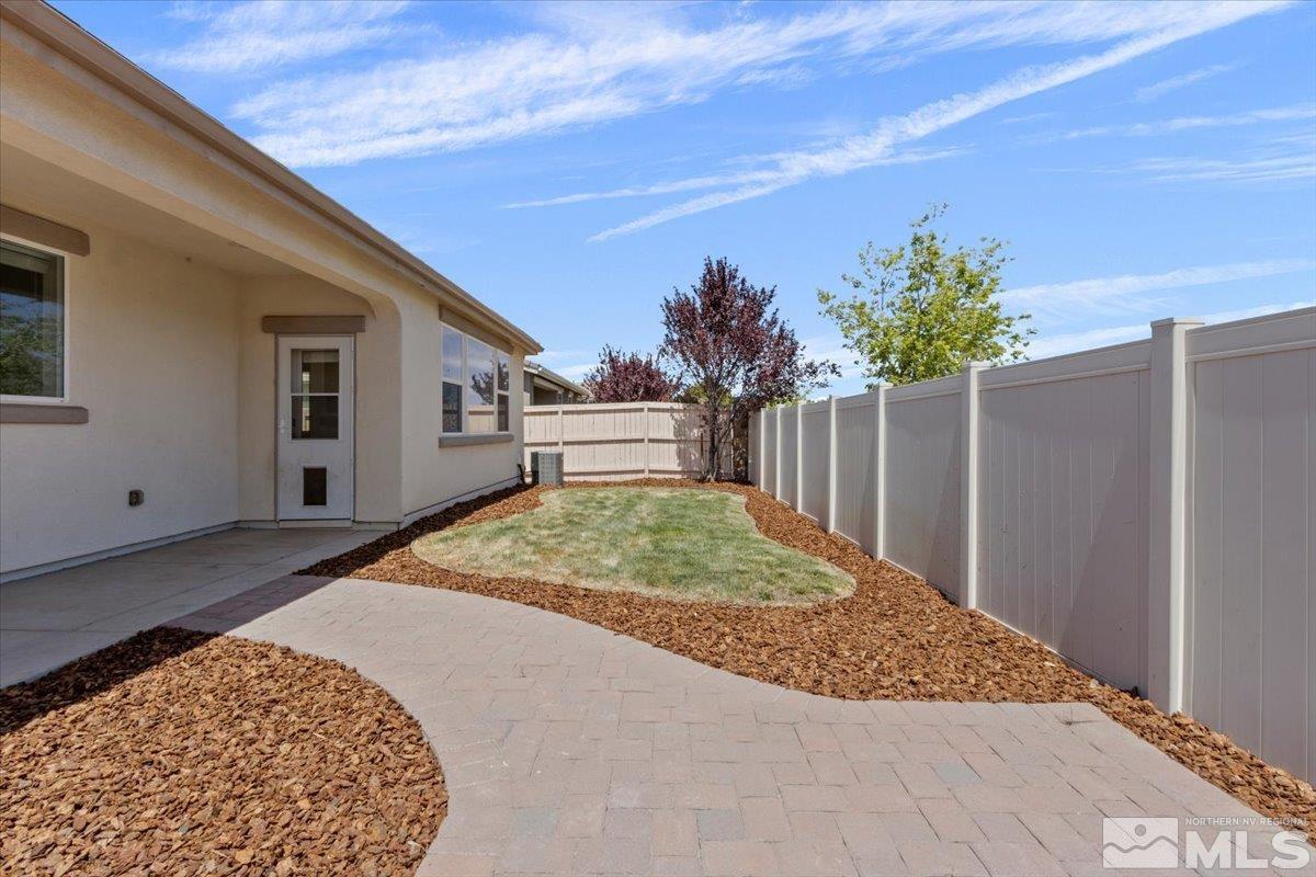 10098 Ignacio Circle Reno, NV 89521 - Photo 30 of 40 a view of backyard with seating space and wooden fence