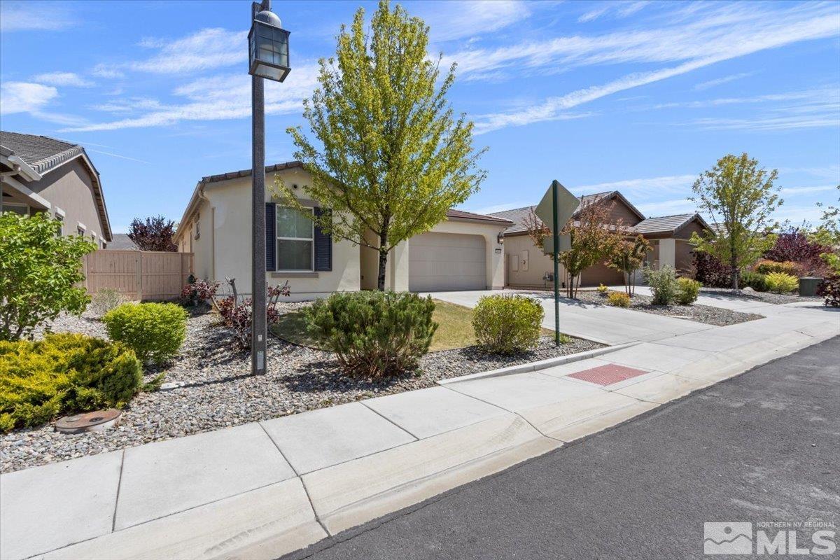 10098 Ignacio Circle Reno, NV 89521 - Photo 34 of 40 a front view of a house with a yard and fountain