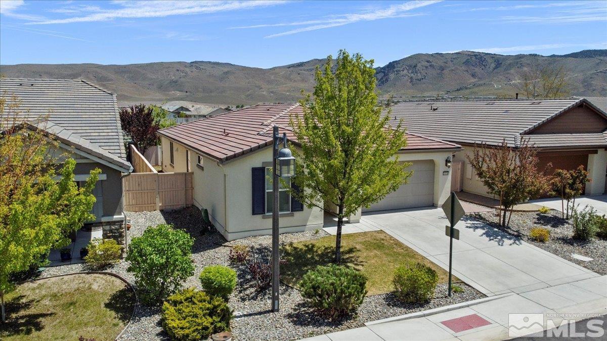 10098 Ignacio Circle Reno, NV 89521 - Photo 4 of 40 a front view of a house with a yard and mountain view
