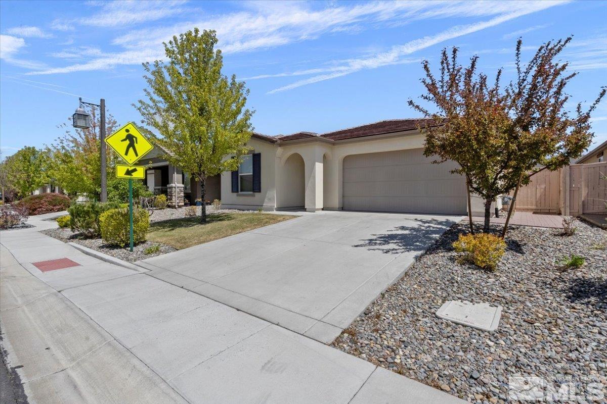 10098 Ignacio Circle Reno, NV 89521 - Photo 7 of 40 a front view of a house with a yard and garage
