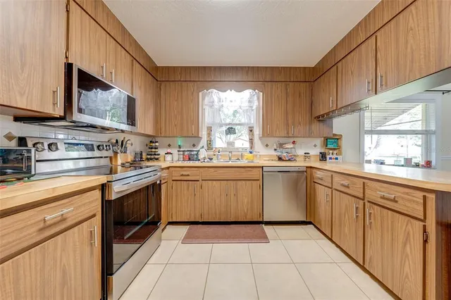 a kitchen with stainless steel appliances granite countertop a sink and cabinets