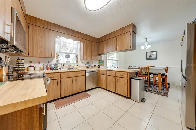 a kitchen with a sink window and cabinets