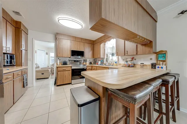 a kitchen with a stove a sink and a refrigerator