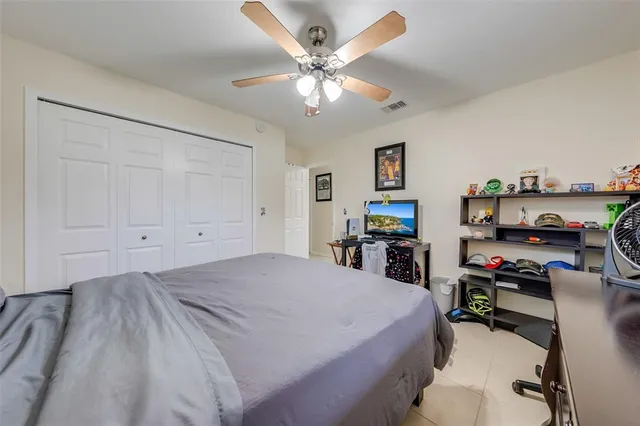 a bedroom with a bed and a tv