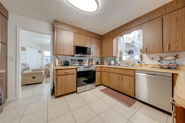 a kitchen with a sink appliances and cabinets