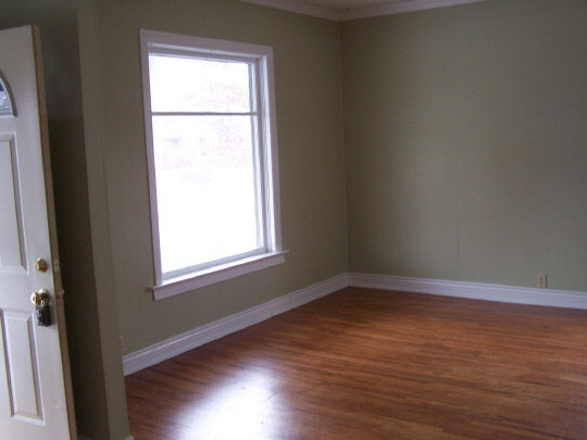 834 8th Street Rochelle, IL 61068 - Photo 2 of 5 an empty room with wooden floor and windows