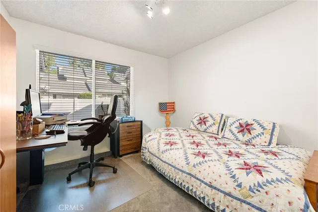 a bed sitting in a bedroom next to a window