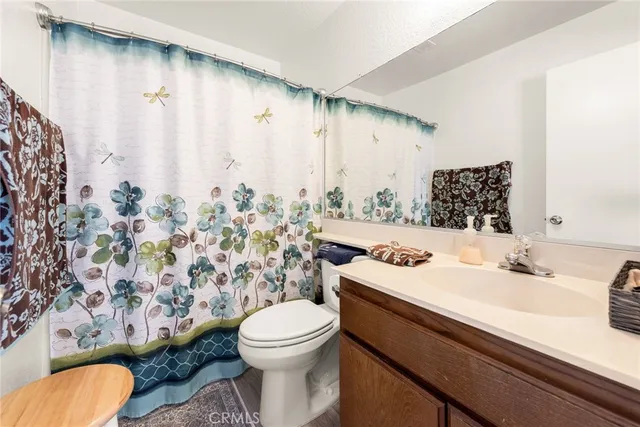 a bathroom with a sink and mirror with toilet