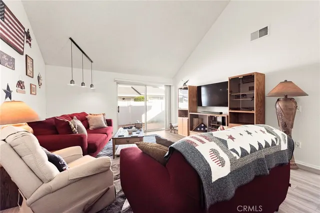 a bedroom with a bed a couch and dresser